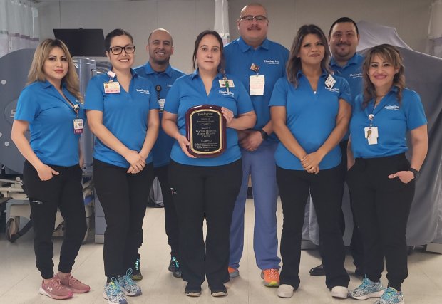 hospital staff holds Healogics award