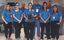 hospital staff holds Healogics award